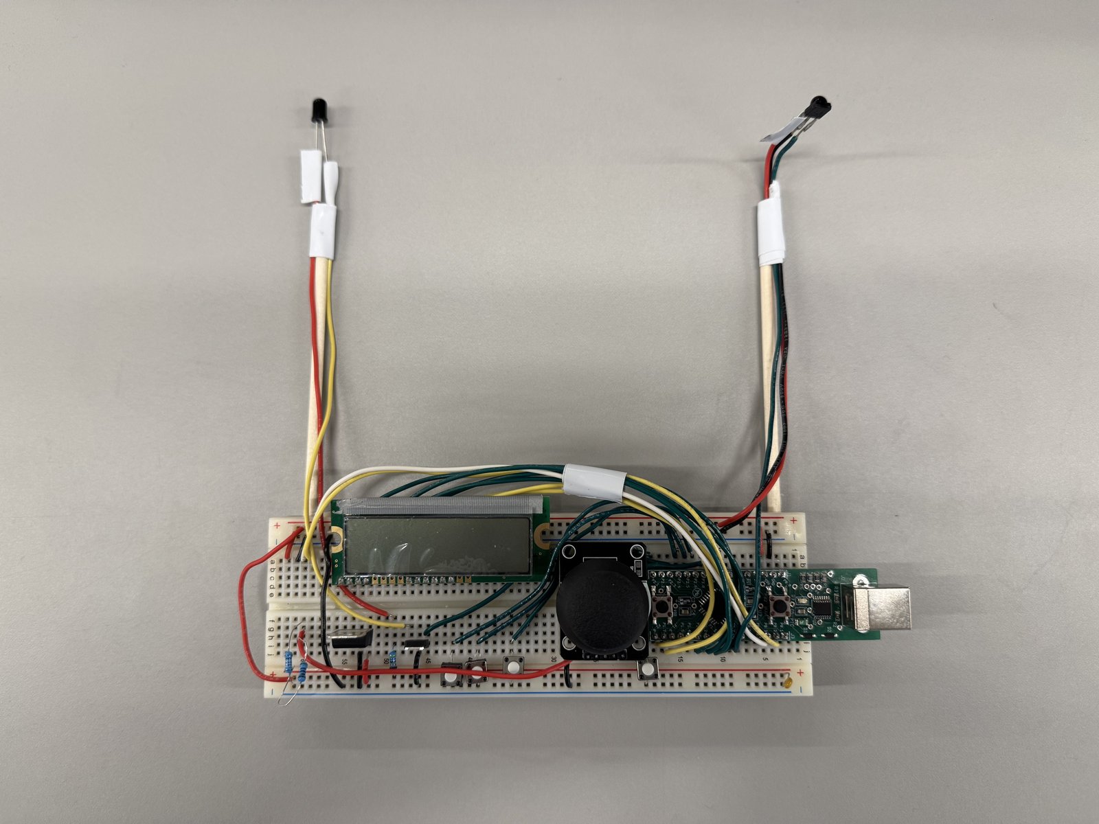 Top-down view of the handheld controller showing EFM8 board, joystick, buttons, and LCD
